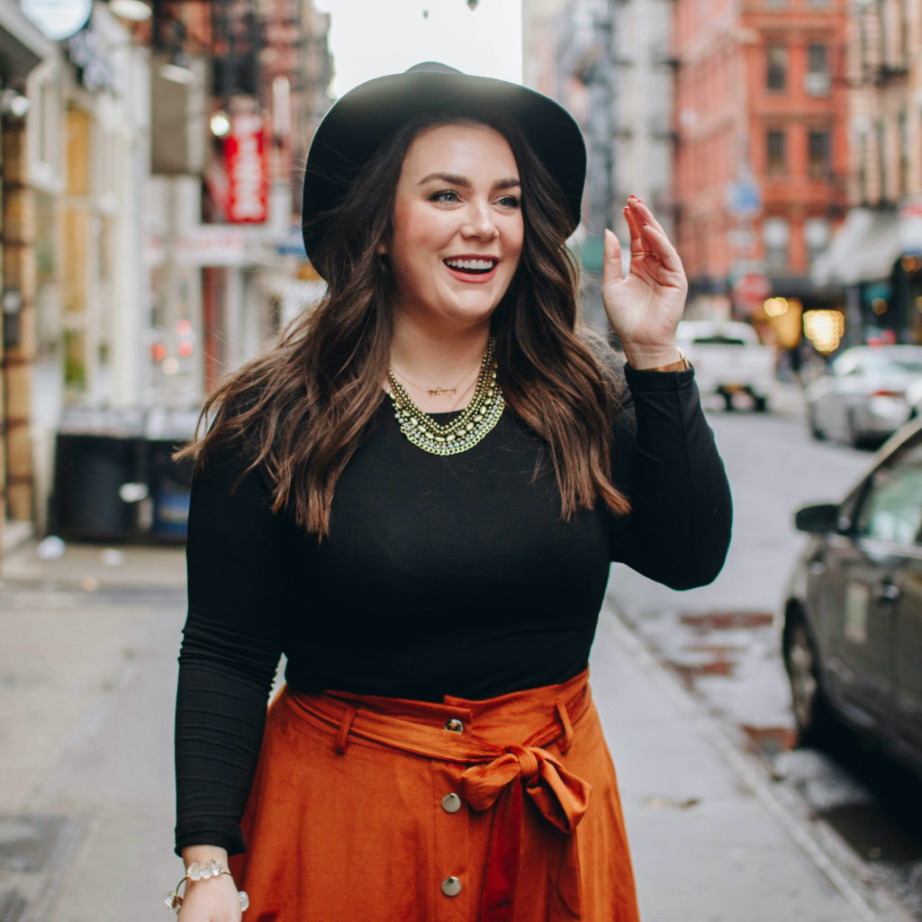 girl on the sidewalk in SoHo, New York laughing